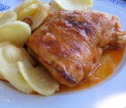 Rooster in wine and tomato sauce