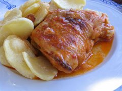 Rooster in wine and tomato sauce